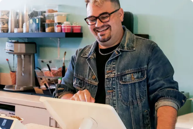 A man happily using a Clover Station