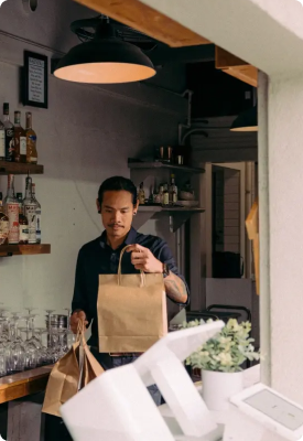 A man preparing a take-out order