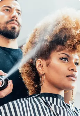A woman getting her hair done at a beauty salon