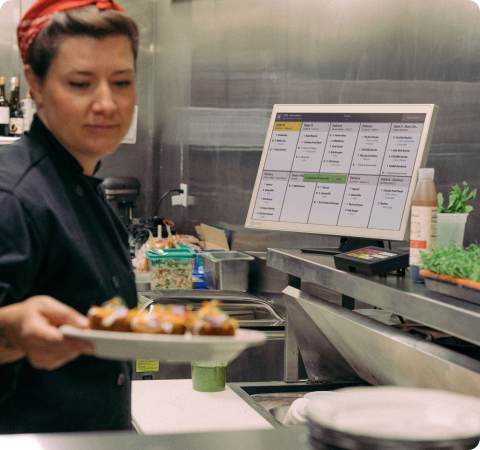A person using a Clover Kiosk to order food from a restaurant
