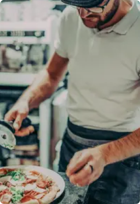 A man serving a pizza