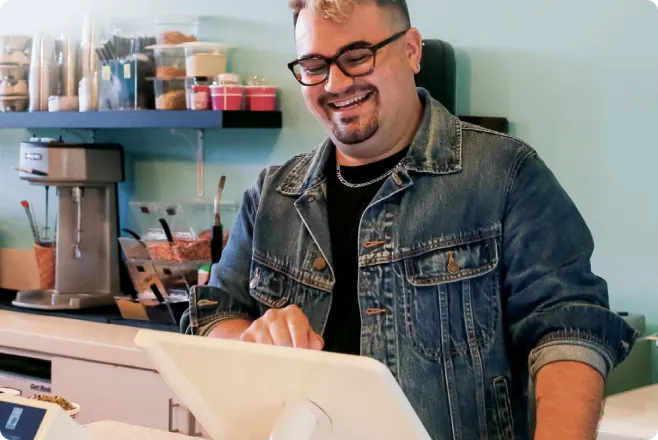 A man happily using a Clover Station